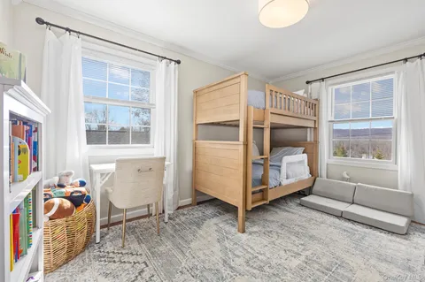 a bedroom with furniture and a window