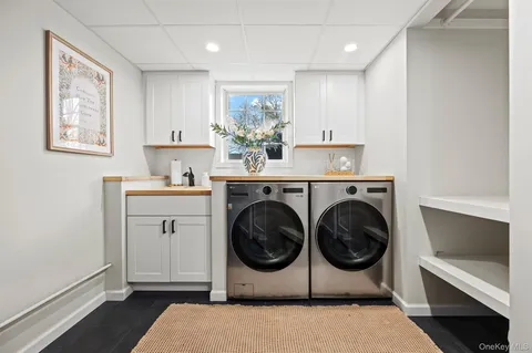 a utility room with sink dryer and washer