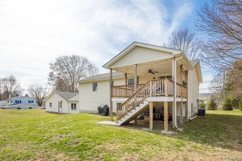 a house that has a big yard and large trees