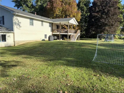a front view of a house with yard and green space