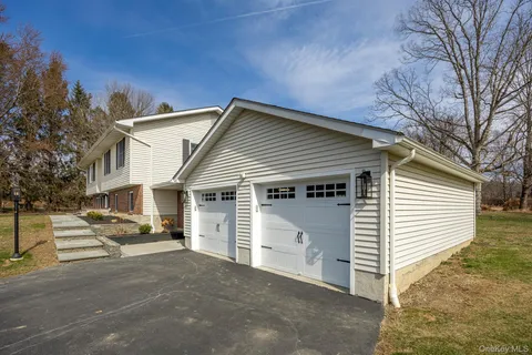 a view of a house with a yard and garage