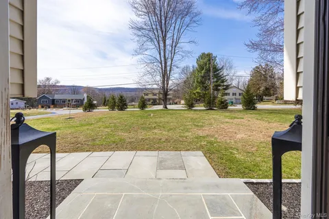 a view of house with outdoor space and swimming pool