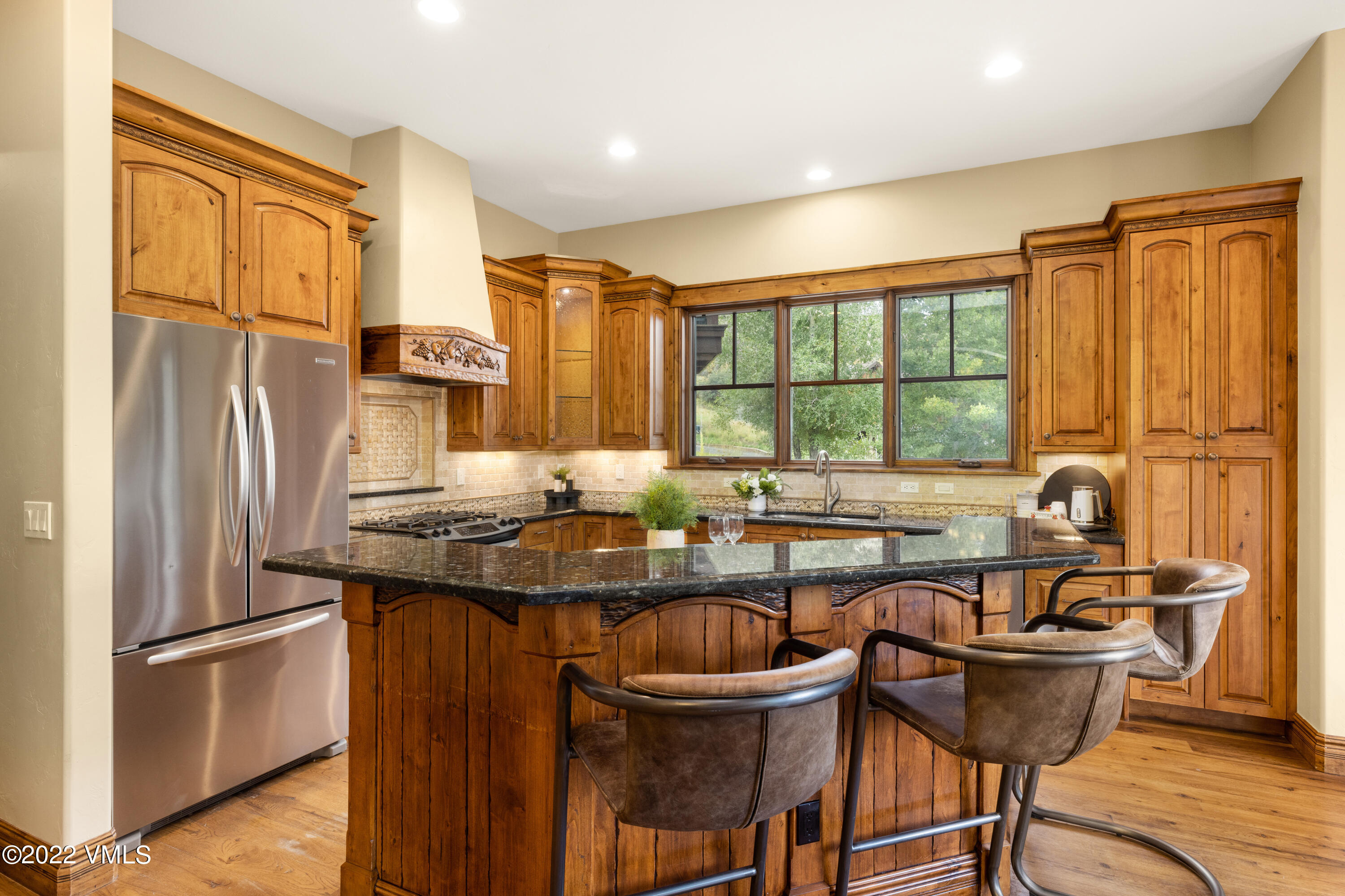 2376 Eagle Ranch Road Eagle, CO 81631 - Photo 11 of 52 a kitchen with stainless steel appliances granite countertop a table chairs and a refrigerator