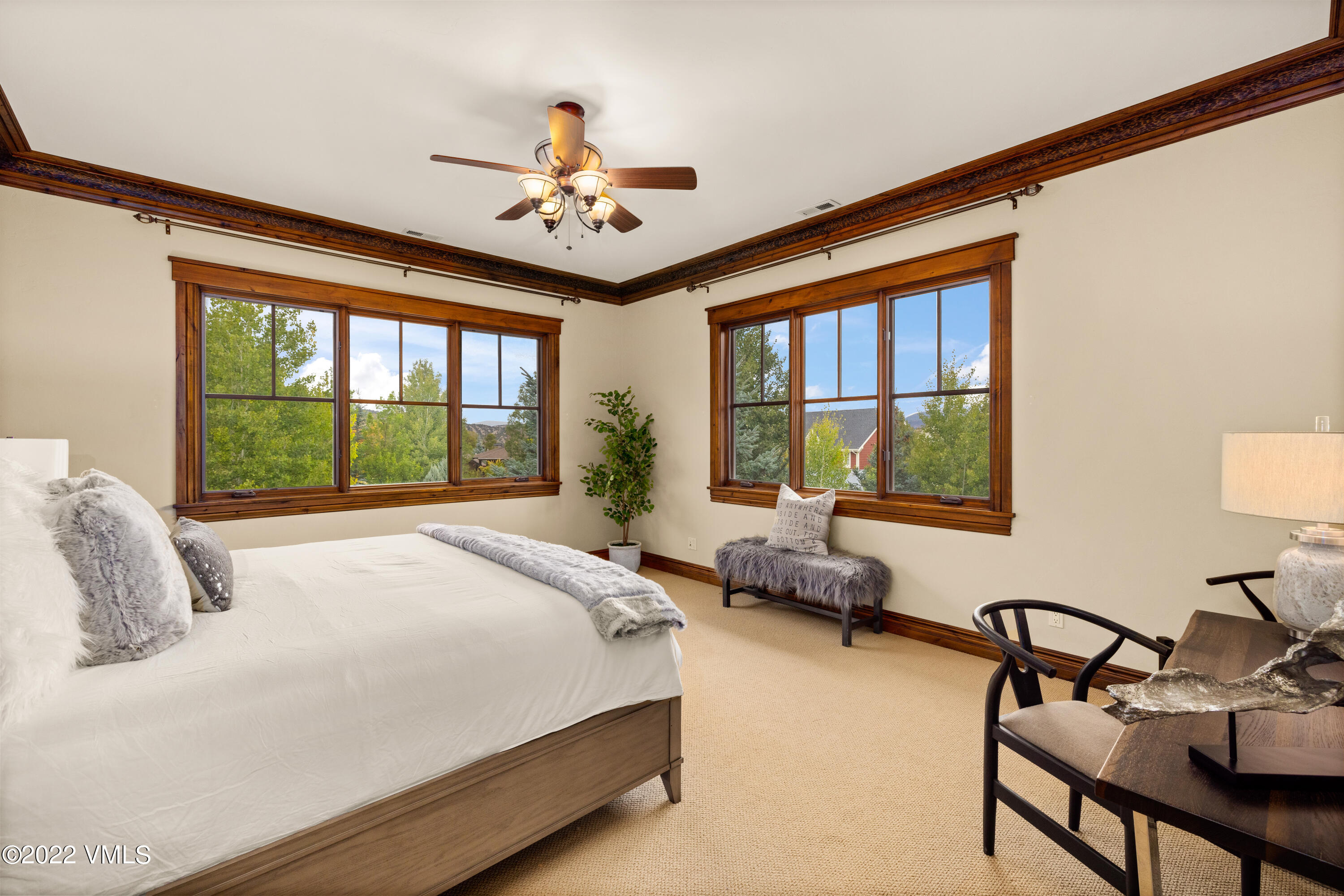 2376 Eagle Ranch Road Eagle, CO 81631 - Photo 19 of 52 a bedroom with a bed and a chandelier