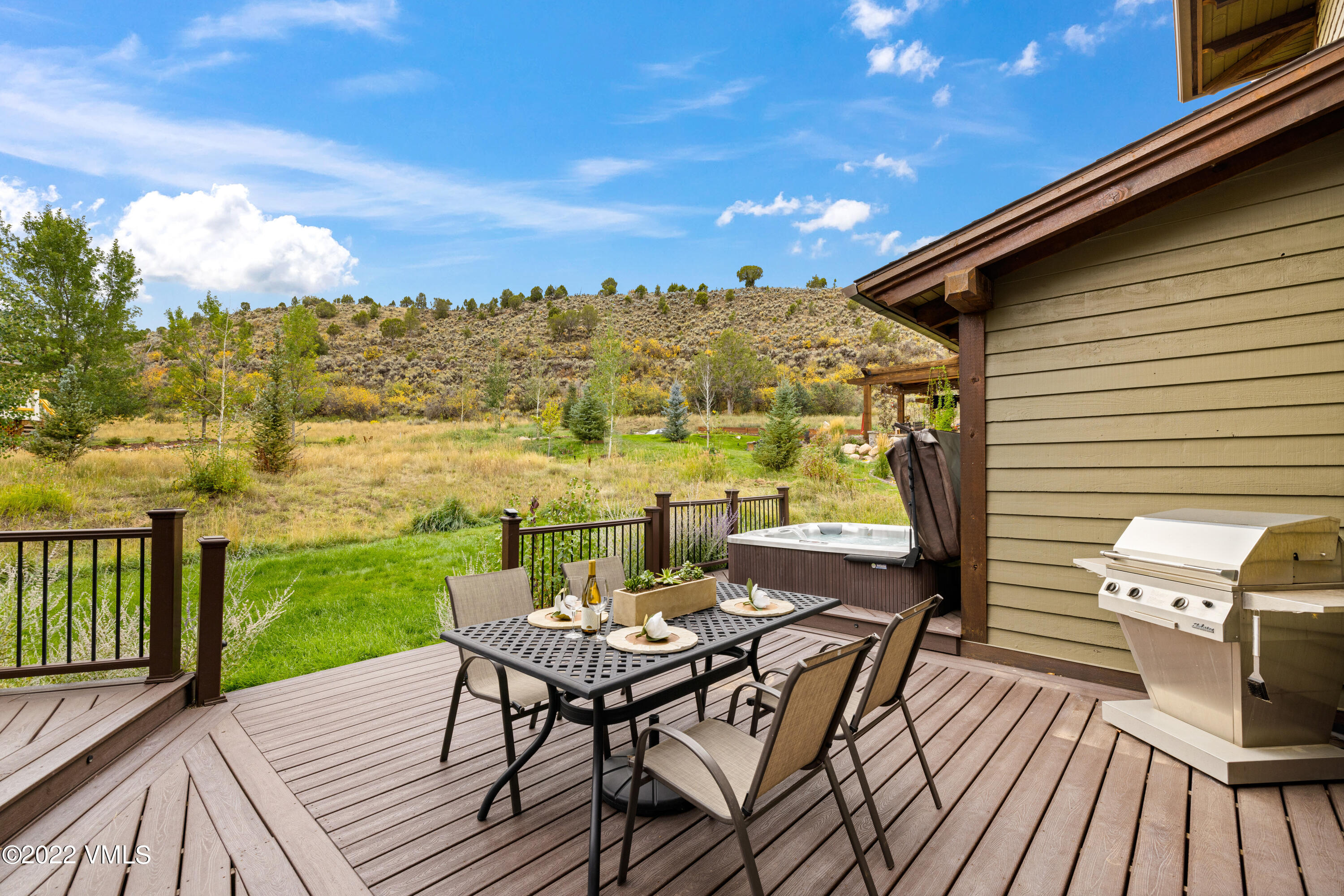 2376 Eagle Ranch Road Eagle, CO 81631 - Photo 23 of 52 a view of a patio with wooden floor table and chairs
