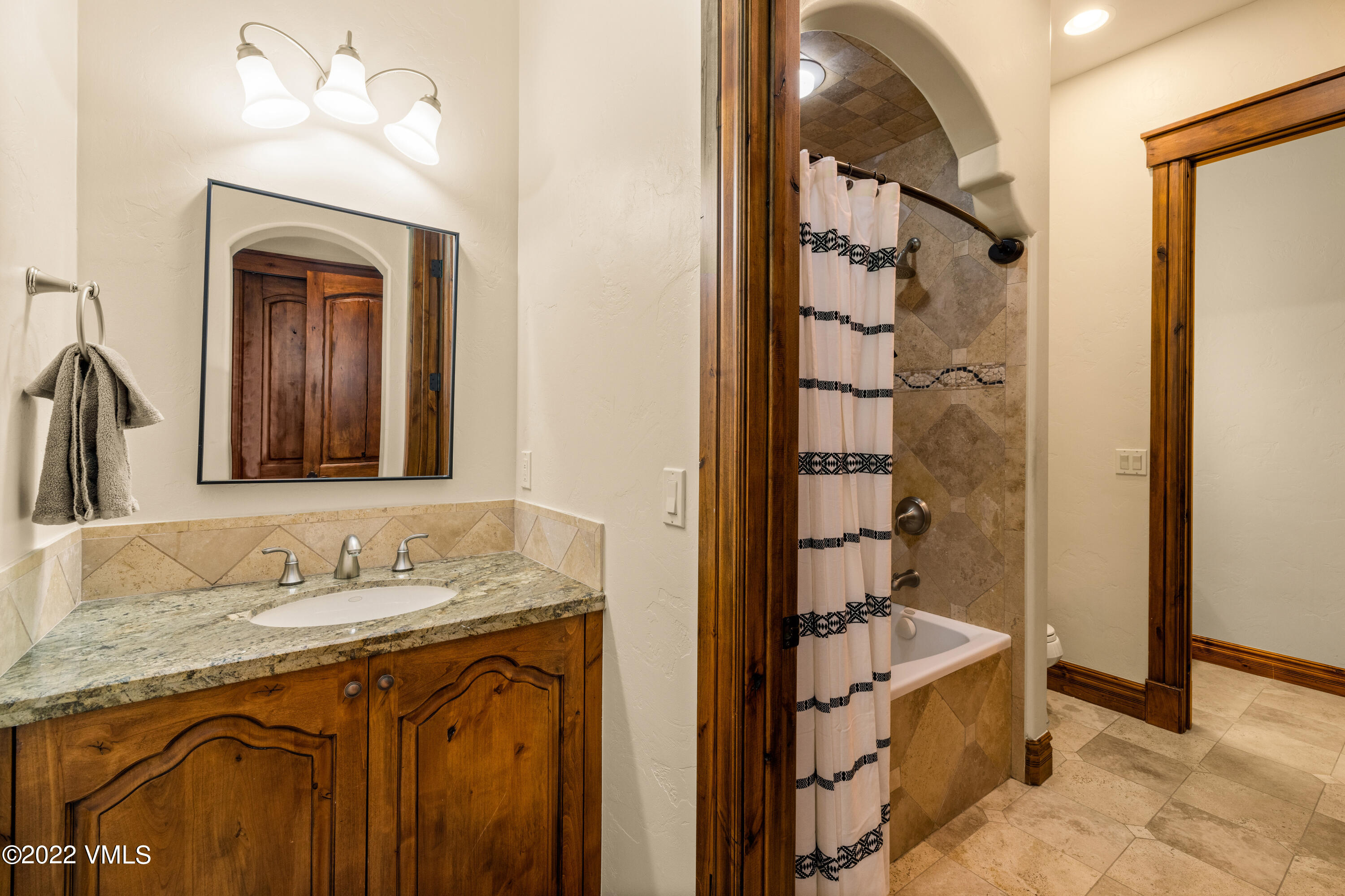 2376 Eagle Ranch Road Eagle, CO 81631 - Photo 32 of 52 a bathroom with a granite countertop sink mirror and shower