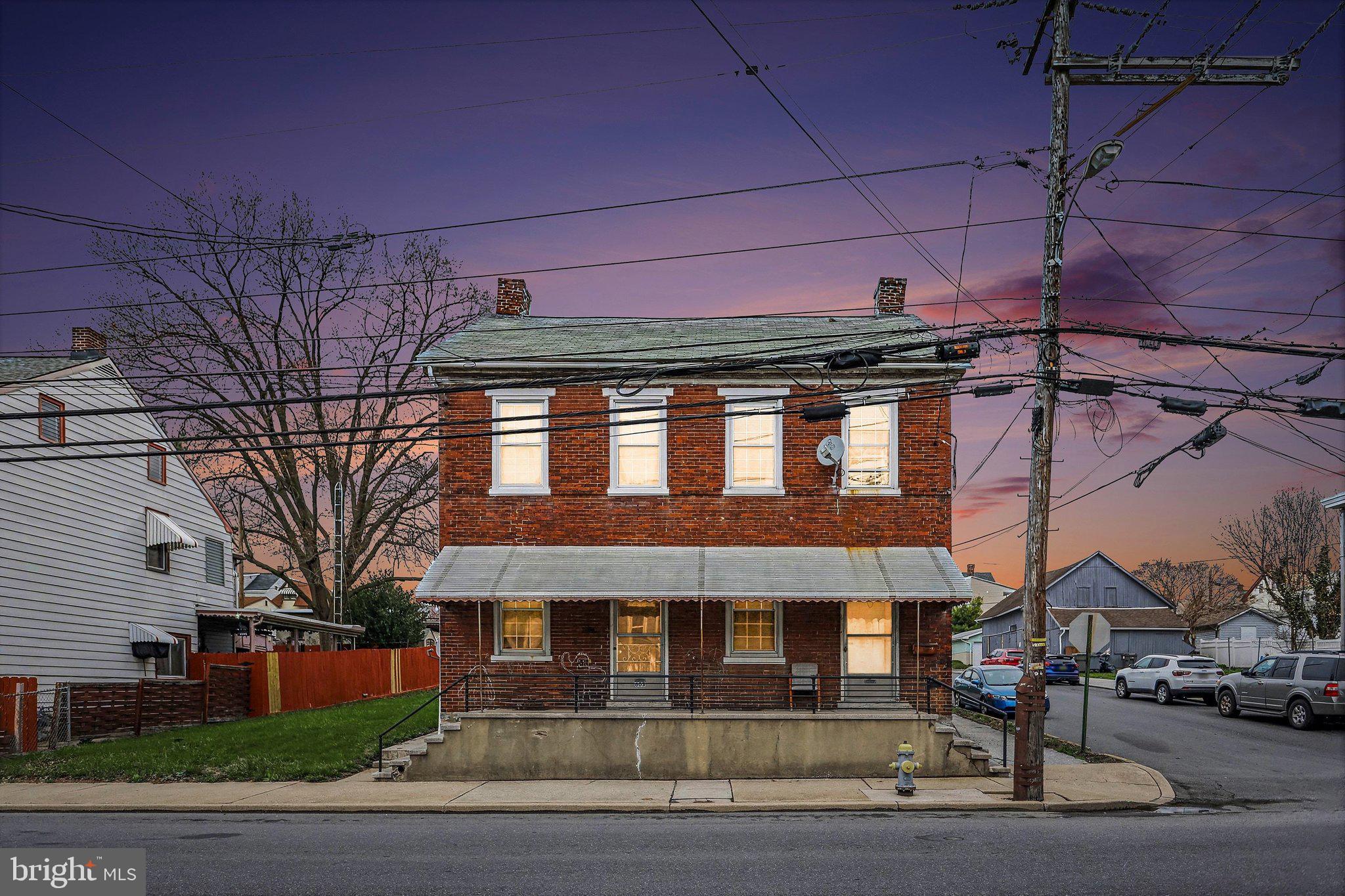 Charming brick duplex at dusk.