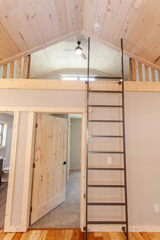 a view of an empty room and fire place