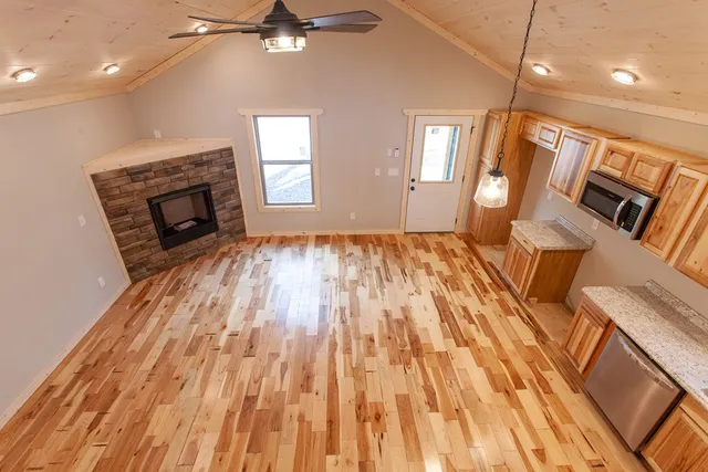 an empty room with wooden floor and a window