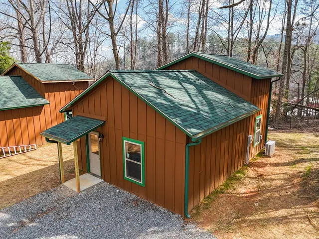 a backyard of a house with barbeque oven table and chairs