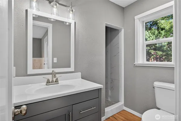 a bathroom with a toilet sink and mirror