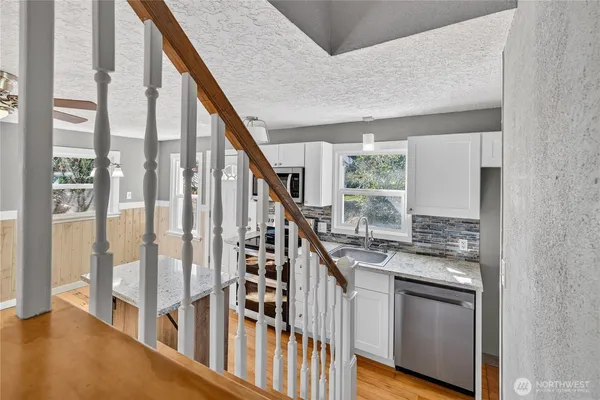 a kitchen with white cabinets and a stove