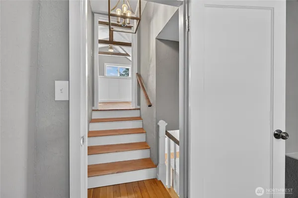 a view of a hallway with wooden floor and entryway
