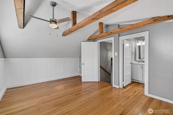 a view of empty room with wooden floor