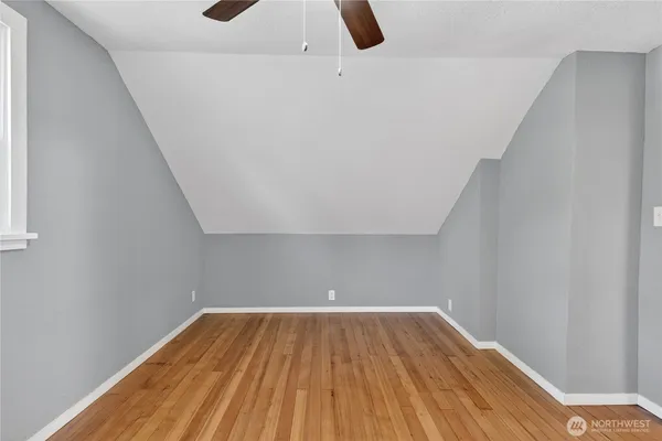 a view of a room with wooden floor and white walls