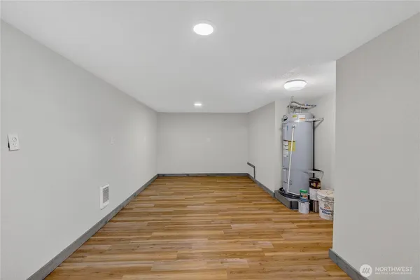 a view of a room with wooden floor