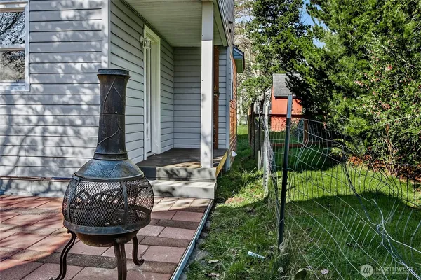 a view of a chairs and table in backyard of the house