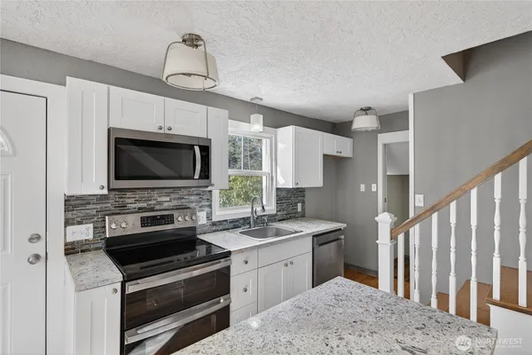 a kitchen with a stove and a microwave