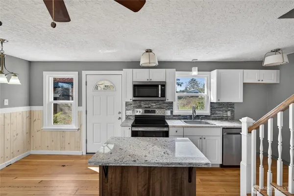 a kitchen with a stove and a white refrigerator