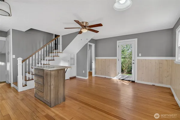 a view of entryway and hall with wooden floor