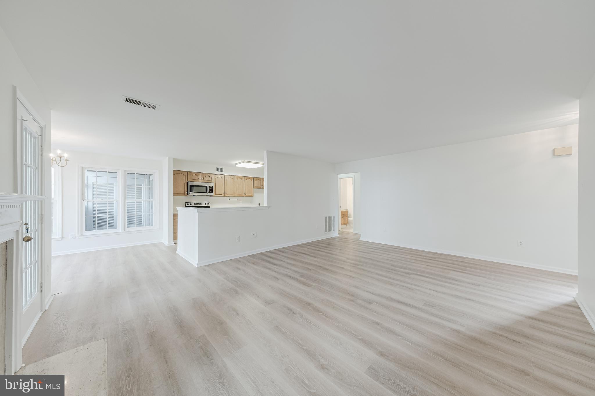 1427 Church Hill Place Reston, VA 20194 - Photo 5 of 30 a view of empty room with wooden floor and window