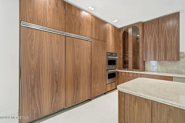 a kitchen with stainless steel appliances a refrigerator and a cabinets