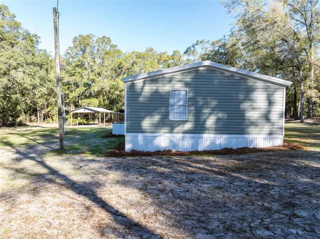 a view of a two chairs with the back yard