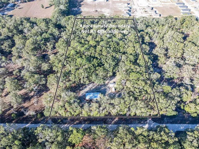 an aerial view of houses with yard