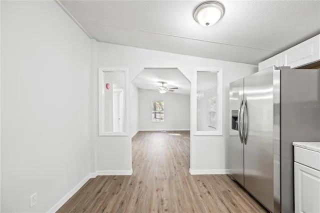 a view of a room with wooden floor and a large window