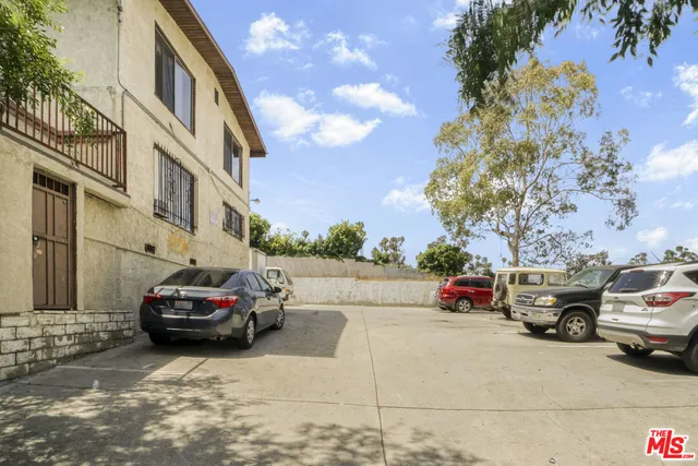 a view of a cars park in front of a building