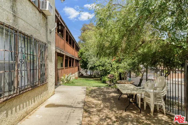 a view of a patio with a table and chairs