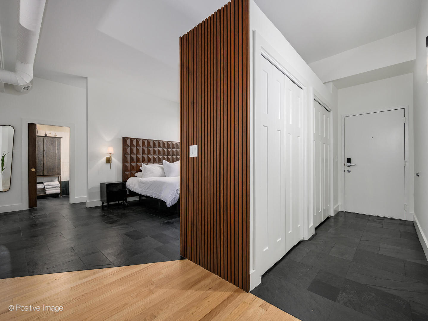 1760 West Wrightwood Avenue, Unit 204 Chicago, IL 60614 - Photo 15 of 28 a view of a bedroom with a couch and wooden floor