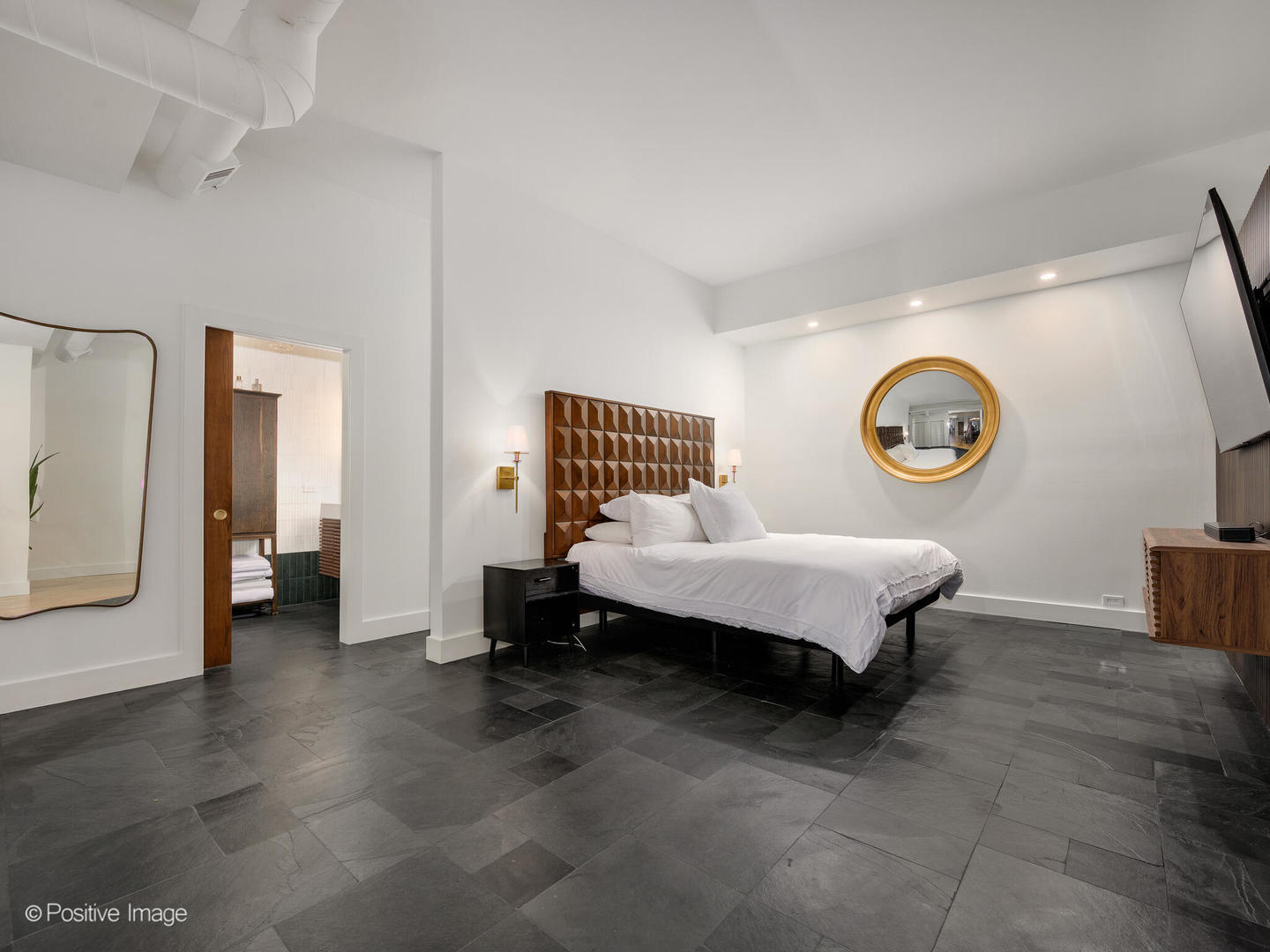 1760 West Wrightwood Avenue, Unit 204 Chicago, IL 60614 - Photo 16 of 28 a spacious bedroom with a bed and a clock