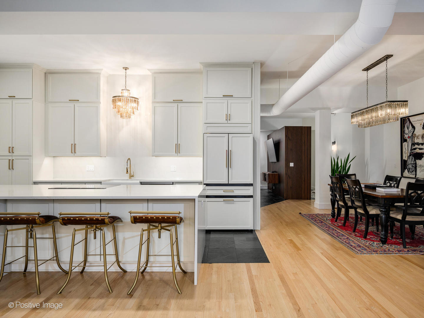 1760 West Wrightwood Avenue, Unit 204 Chicago, IL 60614 - Photo 2 of 28 a kitchen with stainless steel appliances kitchen island granite countertop a table chairs and a refrigerator