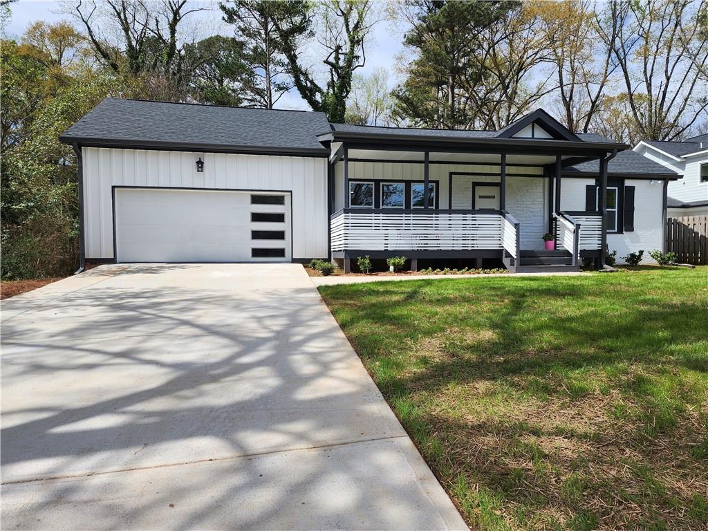 a front view of a house with a garden and trees