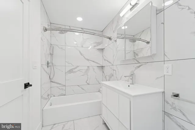 a bathroom with a bathtub a sink a toilet and a shower