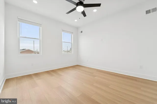 wooden floor in an empty room with a window