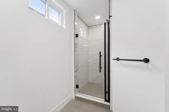 a bathroom with a glass shower door