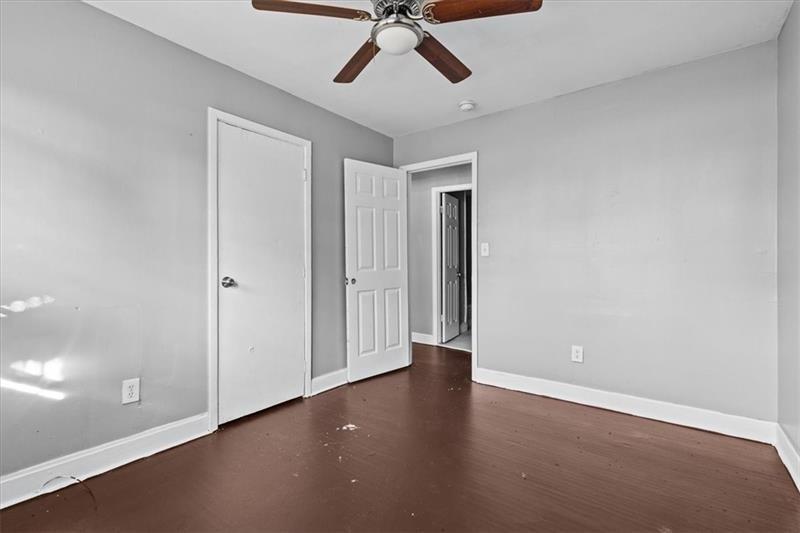 685 Bolton Road Northwest Atlanta, GA 30331 - Photo 9 of 21 an empty room with a ceiling fan and carpet