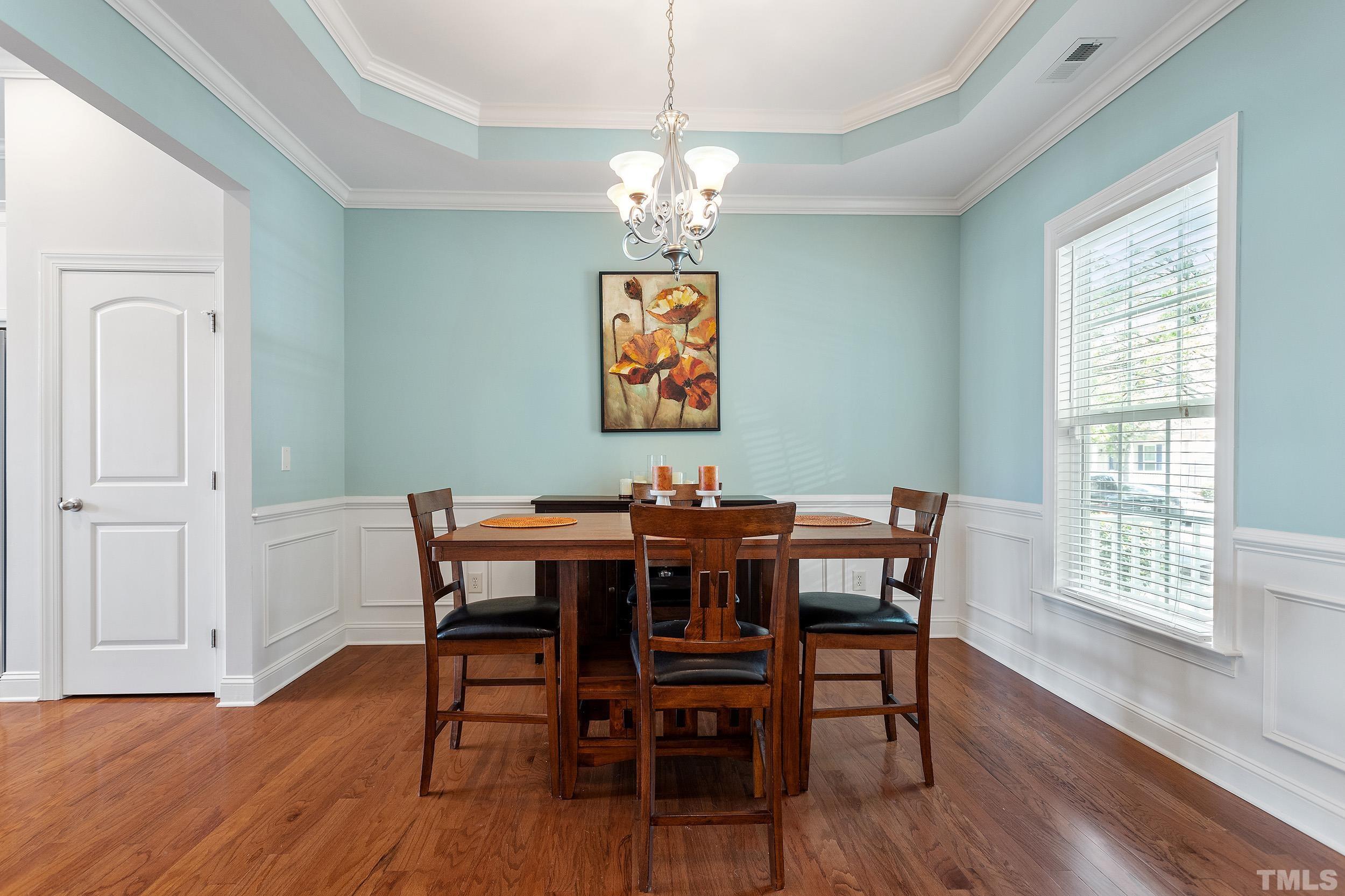 823 Historian Street Raleigh, NC 27603 - Photo 17 of 38 a view of a dining room with furniture wooden floor and chandelier