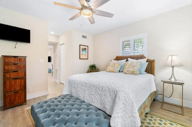 a bedroom with a bed and a flat screen tv