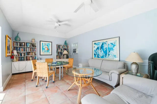 a living room with furniture and a bookshelf