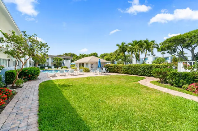 a swimming pool with yard in front of it