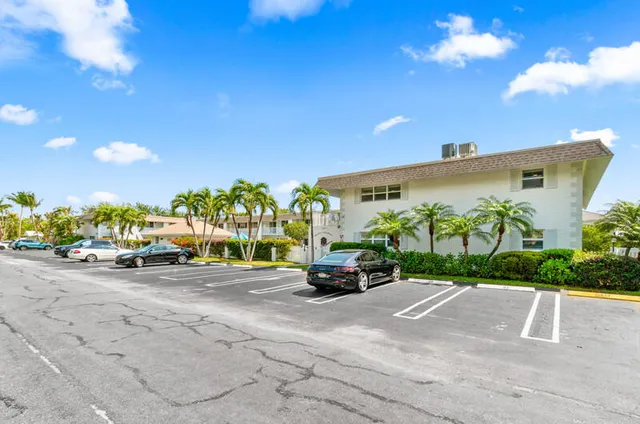 a view of a street with a couple of cars parked in front of it