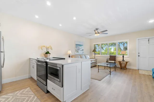 a view of a kitchen with a stove and wooden floor