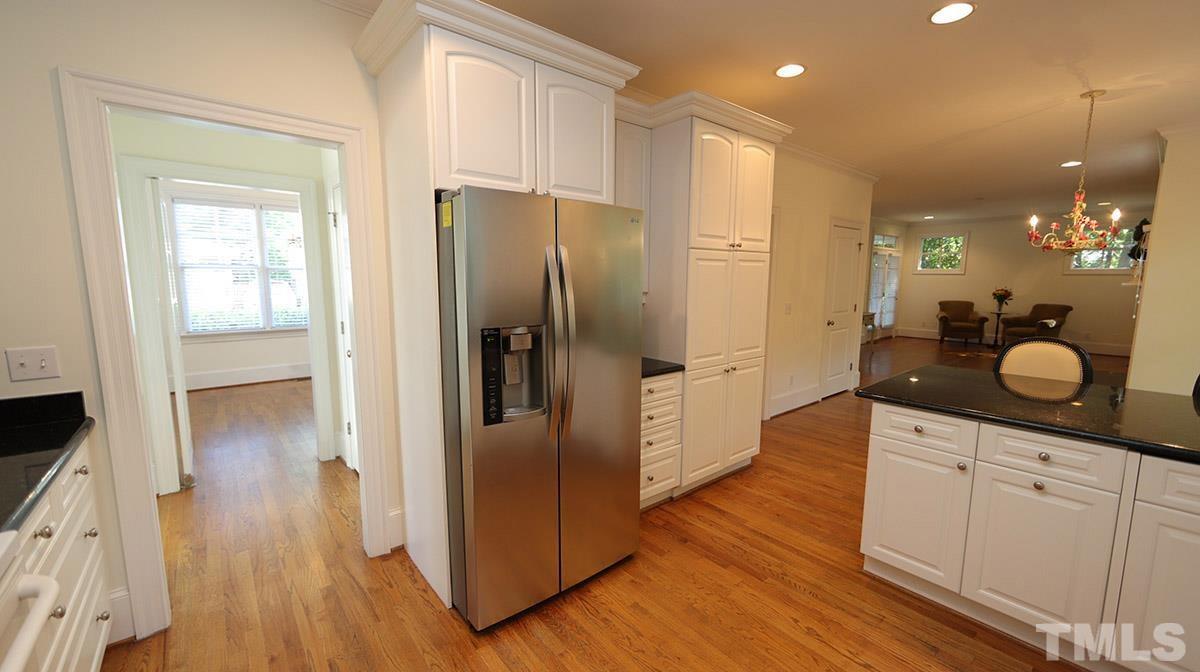 124 Village Mill Place Raleigh, NC 27608 - Photo 14 of 30 Walk through the Kitchen towards the side Screen Porch with a good size closet to the right with bench and storage unit inside.