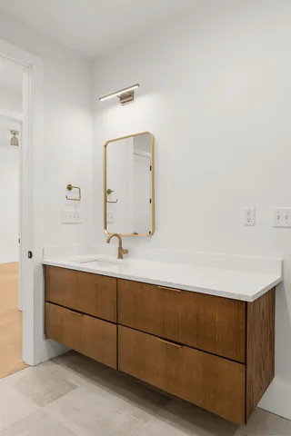 a living room with stainless steel appliances kitchen island granite countertop a sink and cabinets