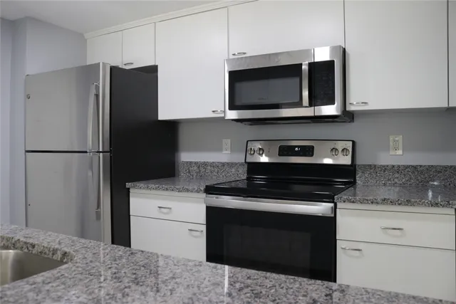 a kitchen with a stove microwave and refrigerator
