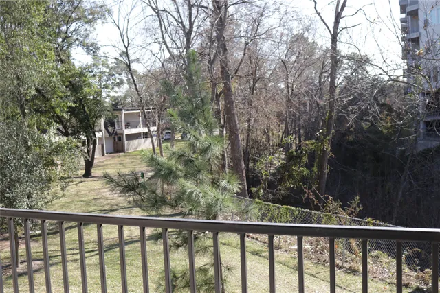 a view of a balcony with wooden fence and floor