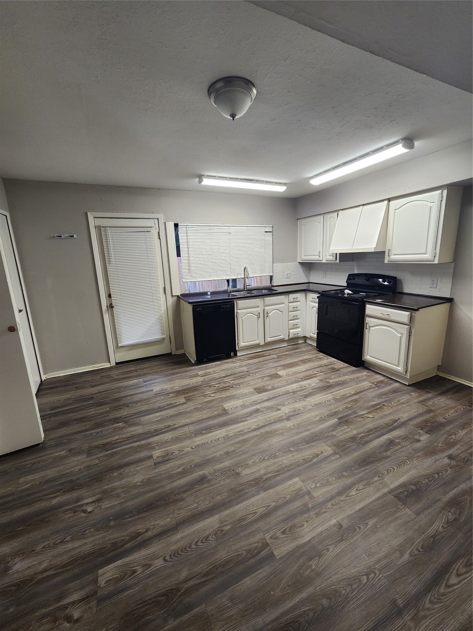 3822 Broken Elm Drive Spring, TX 77388 - Photo 9 of 25 a large kitchen with a wooden floor and stainless steel appliances